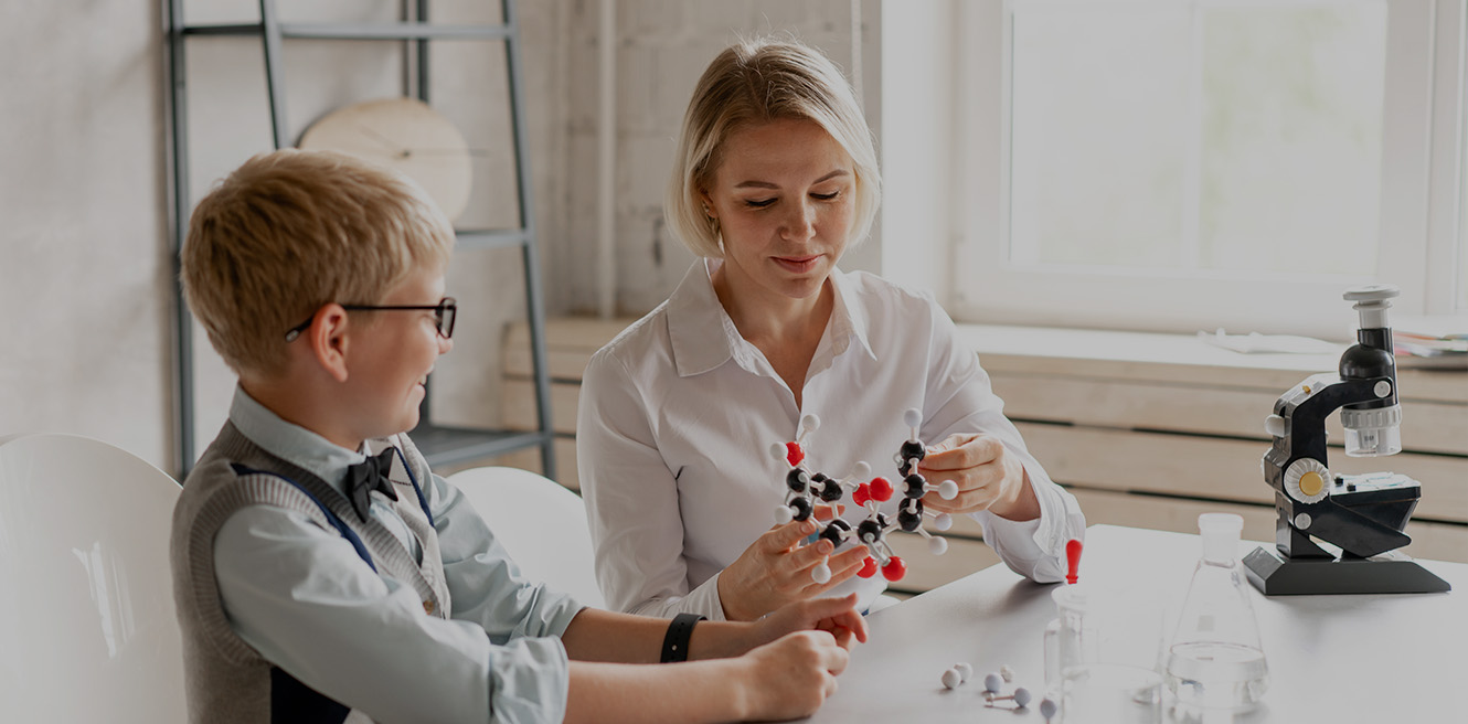 Female science tutor in San Luis Obispo studying chemistry with student